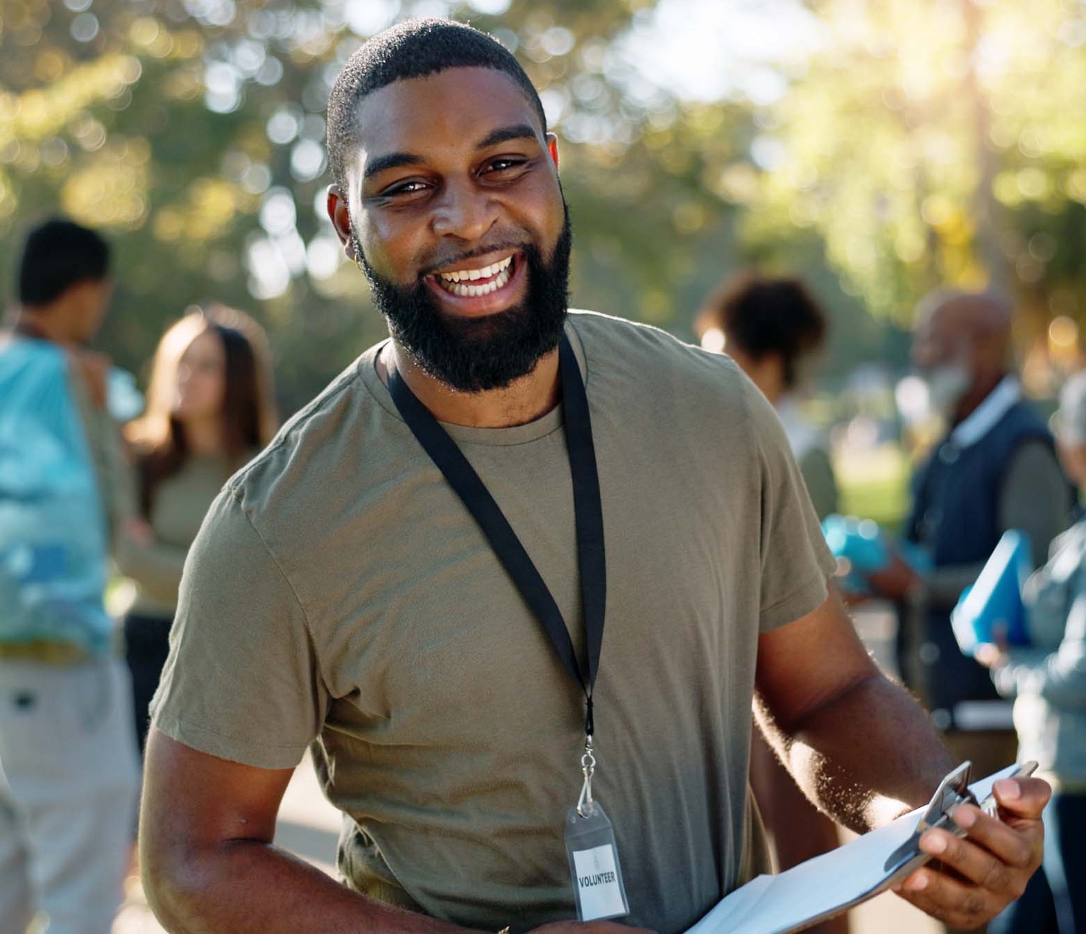 Man, volunteer and happy portrait with clipboard in nature, supervisor and environment sustainability project with group. Recycle, waste management and cleaning outside trash, help and ngo support